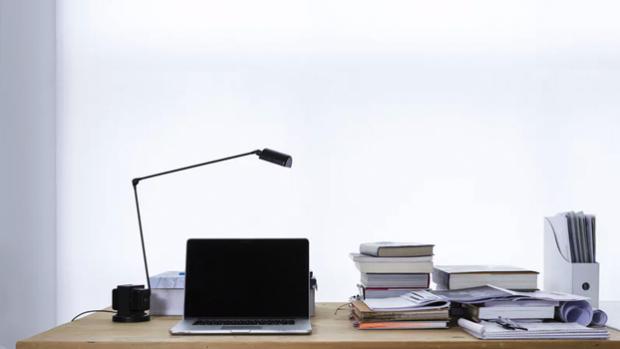 desk with papers and laptop on it