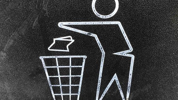 Chalk drawing of figure throwing rubbish in a bin