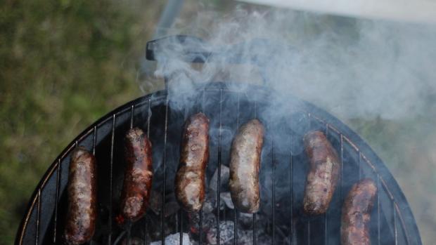 smoky susages on an outdoor grill