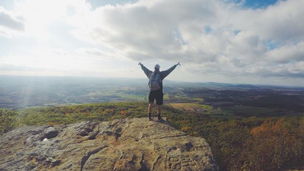 victorious man on a hill top